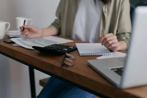Financial-services professional working with reports and a laptop